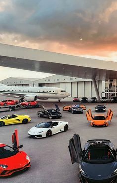 a bunch of cars are parked in front of an airplane