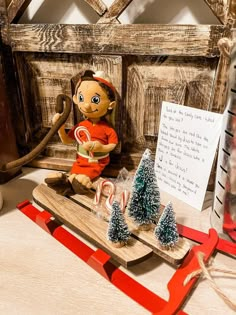 a wooden sleigh with christmas decorations and a stuffed animal