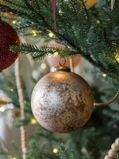 an ornament hanging from the top of a christmas tree