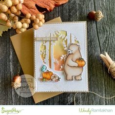 a card with an image of a bear holding a pumpkin