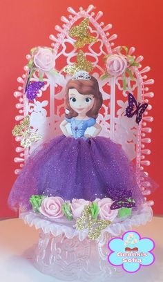 a princess figurine sitting on top of a white chair with pink roses and butterflies