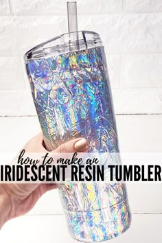 a hand holding a tumbler with the words how to make an iridescent resin tumbler