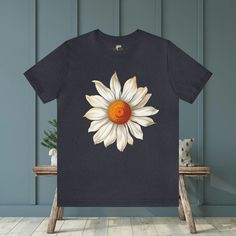 Elevate your style with our Large Daisy Unisex T-Shirt. This classic tee features a prominent large daisy design on the front, offering a clean and stylish look. Available in a wide range of sizes and colors, this versatile tee is the perfect addition to any wardrobe. #16 Boho Classic unisex jersey short sleeve tee fits like a well-loved favorite. Soft cotton and quality print make users fall in love with it over and over again. Ribbed knit collars to bolster shaping. Shoulders are tapered for a better fit over time. Dual side seams hold the garment's shape for longer. Fabric Details Made with 100% Airlume combed and ring-spun cotton, a lightweight fabric (4.2 oz/yd² (142 g/m²)) that is easy to layer, breathable. Perfect for active and leisure wear. Style Features The retail fit is perfect Cotton Short Sleeve T-shirt With Sunflower Print, Summer Daisy Print Short Sleeve T-shirt, Casual Cotton T-shirt With Sunflower Print, White Cotton T-shirt With Daisy Print, Summer Crew Neck T-shirt With Daisy Print, Graphic Tee With Daisy Print And Crew Neck, Daisy Print Graphic Tee With Crew Neck, Graphic Tee With Daisy Print Crew Neck, Summer Daisy Print Crew Neck T-shirt