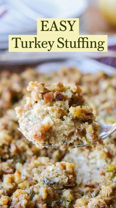 a spoonful of stuffing being lifted from a casserole dish