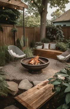 a fire pit surrounded by chairs and trees