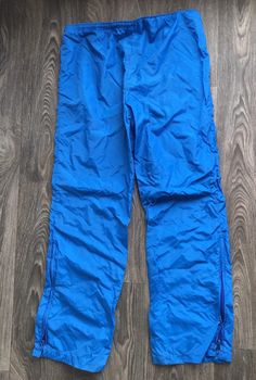 Fantastic 70's Nike full runner/track suit. Jacket is 1/4 zip with zip kangaroo pocket and huge swoosh on back. Pants have drawstring waist and zip ankles. Light wear (pants have some unraveling at waist---see pics, still completely functional but allows the waist seam to flip up) but overall excellent condition. Never ending style! Check out other sensational vintage Nike gear in my shop https://www.etsy.com/shop/sweetVTGtshirt?section_id=11916484&ref=shopsection_leftnav_4 Label: Nike. USA Winter Sports Parachute Pants With Pockets, Sporty Parachute Pants For Hiking, Sporty Full-length Parachute Pants For Outdoor, Sporty Full Length Parachute Pants For Outdoor, Sporty Pants With Zip Fly For Sports, Sporty Parachute Pants For Winter Sports, Sporty Parachute Pants For Outdoor, Casual Blue Hiking Pants, Sporty Pants For Winter Sports