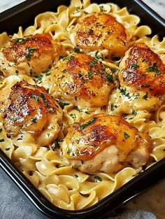 some chicken and noodles in a pan on a table