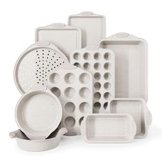 an assortment of white dishes and utensils