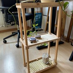 a small wooden shelf with some plants on it