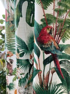 the curtains are decorated with colorful birds and tropical leaves