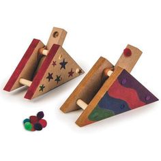 two wooden toys with different shapes and colors on the top one is shaped like a triangle