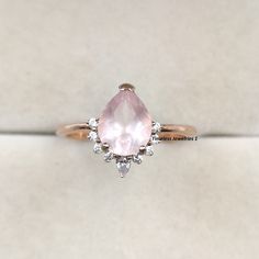 Natural Rose Quartz Engagement Ring, Pear Cut Dainty Pink Quartz Ring, Promise Ring, Crystal Ring, Valentine's Day Jewelry Gift for Couple  ❥ RING DESCRIPTION :- ✦ Handmade, high-quality item! ✦ Material: SOLID 14K/18K/24K GOLD (can be made in white/rose/yellow gold) ✦ Center Stone:  Rose Quartz ✦ Stone Shape: Pear Shape Facet Cut ✦ Dimensions:- 7 X 9 MM ✦ Color: Pink ✦ Side Stone: Cubic Zirconia  ✦ Color: Transparent ✦ Clarity: Eye Clean  ❥ FINISHES :- ✦ 925 Sterling Silver, 22k Yellow Gold, Rose Gold, White Gold or Black Gold Plating.  ❥ NOTE :-  ✦ Due to the nature of the gemstones, the appearance of each piece may slightly vary in color. ✦ The shades of each Rose Quartz vary since they are natural and untreated. If you have a shade preference, please indicate it in the notes section. ✦ Rose Quartz Engagement Ring, Pink Quartz Ring, Rose Quartz Ring Engagement, Engagement Ring Pear, Quartz Engagement Ring, Ring Crystal, Stone Rose, Couple Ring, Pear Engagement Ring