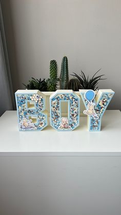 a small planter with the word baby spelled out in it's centerpiece