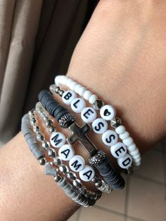 *This stack can be personalized to say any name/saying that you would like.* PLEASE ONLY ONE(1) CROSS BRACELET PER SET!! **PLEASE ONLY ONE(1) GRAY HEART BRACELET PER SET **Bracelets can be purchased single or in sets of 2,3,4,5 or all 6(as pictured).** *Will make a perfect Mother's Day gift for mama ,grandma or even Aunt!* *Please roll on bracelet rather than stretch on to prevent breaking.* *Please measure wrist before ordering.* **All sales are final as these are custom bracelets.** Auntie Bracelet, Jewelry Booth, Heishi Bracelets, Gray Heart, Kandi Inspo, Homemade Bracelets, Christian Bracelets, Stack Bracelet, Friendship Bracelets With Beads