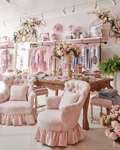 a room filled with lots of pink furniture and flowers on the wall next to it