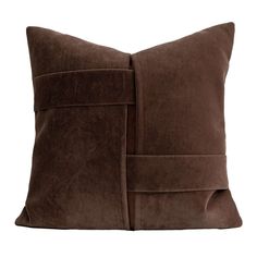 a brown pillow that is made out of sued and has a square design on the front