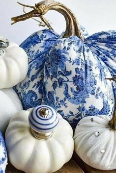 blue and white pumpkins are stacked on top of each other