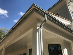 the corner of a house with a metal gutter