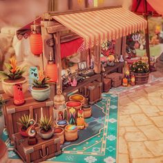 an image of a doll house with many potted plants on the floor and in front of it