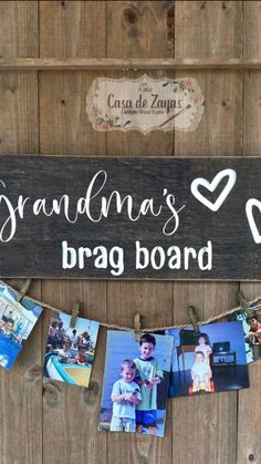 a sign that says grandma's brag board hanging from a clothes line with photos on it