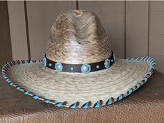 Copper patina berry Conchos have a turquoise appeal. Mounted on chocolate brown leather. Ties on with leather lace and a deer antler slider bead. 23" Hat sold separately Blue Bohemian Hat Bands, Handmade Southwestern Turquoise Hat Bands, Artisan Blue Hat Bands For Country Events, Southwestern Turquoise Hat Bands For Country Events, Handmade Rustic Brown Hat Bands, Southwestern Turquoise Hat Band For Ranch, Southwestern Turquoise Hat For Ranch, Southwestern Style Turquoise Hat For Ranch, Artisan Turquoise Hat For Western-themed Events