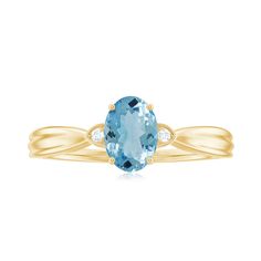 an oval cut blue topazte and diamond ring in yellow gold with two diamonds on each side