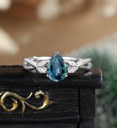 a close up of a ring with a blue stone on it's center piece