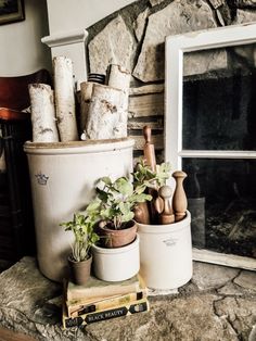 there is a potted plant and some books on the table next to an open window