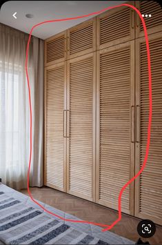 an image of a bedroom with closets in the background and a red line drawn across the room