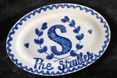 a blue and white plate with the letter s on it