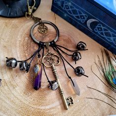 a bunch of keys that are sitting on a wooden table next to some other items