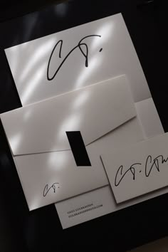 two envelopes with autographs on them sitting next to each other