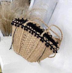 "This elegant crossbody straw bag is touched with adorable black mini pom poms around the edge. Fully lined with black cotton fabric and features with twisted shoulder straps. Perfect for spring and summer vacation or a trip to the beach. Material: straw Closure: drawstring Measurement: 12\" wide x 8.5\" high Shoulder strap: 16\" drop Color: camel brown 1 Interior pocket for cellphone Very convenient for beach goers. Ready to Ship from Los Angeles, California." Spring Black Straw Beach Bag, Casual Handmade Black Straw Bag, Casual Black Handmade Straw Bag, Black Beach Bag With Braided Handles For Spring, Spring Black Beach Bag With Braided Handles, Black Woven Crochet Bag For Summer, Trendy Crochet Bag With Tassels For Beach, Trendy Black Handmade Straw Bag, Casual Black Straw Bag