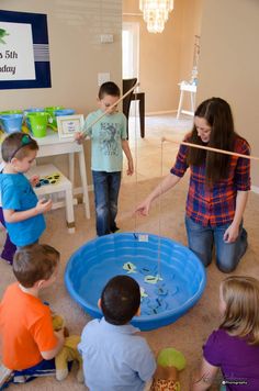 a woman teaching children how to use an inflatable pool