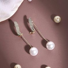 Discover the elegance of Korean jewellery with our Stud Earrings featuring a cute pearl and gold-plated design. These statement earrings are crafted to add a touch of sophistication to any outfit. The simple yet unique design makes them perfect for everyday wear or special occasions. Ideal as a gift for women, these earrings combine the timeless charm of pearls with the luxurious appeal of gold plating. Surprise her with a beautiful, versatile accessory that embodies the best of Korean fashion. Rose Gold Pearl Earrings For Party, Minimalist Pearl Earrings For Parties, Minimalist Pearl Charm Earrings For Party, Minimalist Pearl Earrings With Pearl Charm For Parties, Minimalist Pearl White Earrings For Party, Pearl White Single Earring For Parties, Korean Jewellery, Makeup Accesories, Korean Jewelry