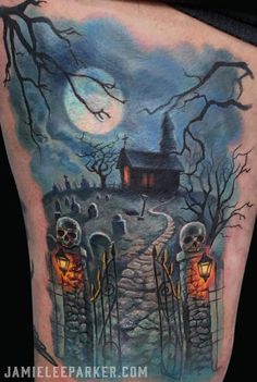 a halloween scene with pumpkins and skeletons on the side of a woman's thigh