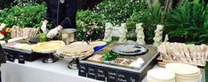 a buffet table with plates and food on it