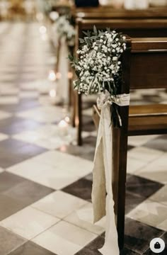 the aisle is decorated with baby's breath flowers and burlock tied to pews