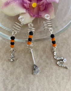 READY TO SHIP-1 Day shipping--the set shown is the one you will receive.  Adorn your locs, braids, twists, or dreads with this set of three Halloween themed hair charms.  Each has orange and black glass beads with a Tibetan silver witch hat, broom, and snake charm.  Size: Opening as shown is 8mm Created with 20g tarnish resistant silver wire.   Perfect for your costume or just to show your love for all things Halloween.🎃 All components are lead and nickel free. Dread Braids, Hair Charms, Jewelry Halloween, Loc Jewelry, Witch Broom, Witch Costume, Halloween Jewelry, Witch Hat, Black Glass