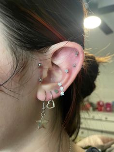 a close up of a person with ear piercings on their ears and one behind the ear