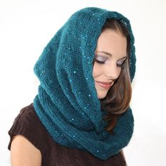 a woman wearing a blue knitted scarf