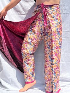 - These unique and beautiful pure Sari Silk pants are from India, these are double layer so it is not see-through at all.  - One of the best parts these pants are REVERSIBLE, so you are basically paying for one and getting two.  - These wrap pants are so comfortable to wear. These pants are made of quality silk blend or sari fabric. These are perfect pants for evening wear, beach cover-ups, casual wear, formal wear, party wear or use your own exciting look. - it will look amazing with a basic crop top, basic tees, cotton shirts, and basically with anything you want.  - There are strings that you can tie around the waist, it is up to you how tight or lose you want.  Care: - We recommend hand washing and tap/cold water - Machine wash, gentle cycle - Do not bleach - Air dry Note: Color may va Wrap Around Pants, Pant Design, Basic Crop Top, Wrap Pants, Water Machine, Beach Cover Ups, Perfect Pant, Sari Fabric, Sari Silk