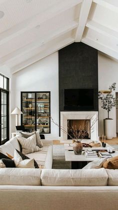 a living room filled with furniture and a fire place in the middle of a room