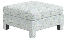 the footstool is made out of fabric and has a flower pattern on it