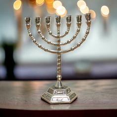 a silver menorah sitting on top of a wooden table