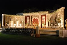 an elaborately decorated outdoor wedding venue at night