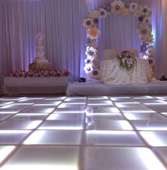 the dance floor is lit up with flowers