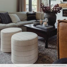 a living room filled with furniture and a fire place next to a window covered in curtains