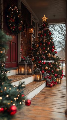 a christmas tree on the front porch with red and gold ornaments, lit by candles