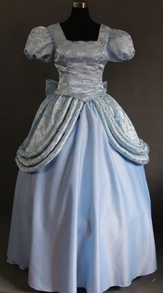 a blue dress is on display in front of a mannequin's head